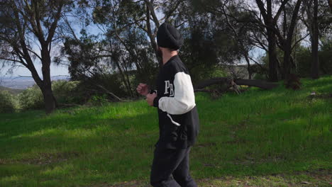 Punjabi-Sikh-Man-Wearing-Turban-Jogging-Downhill-With-Nature-Scenery-In-Background