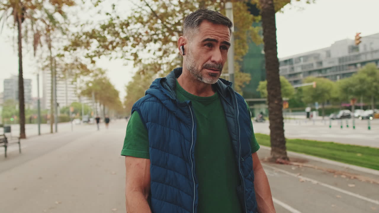 Man Walking in Urban City Park