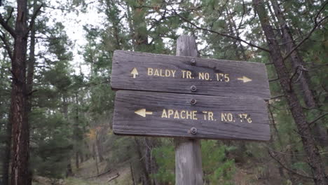 a hiking trail sign points two different directions.