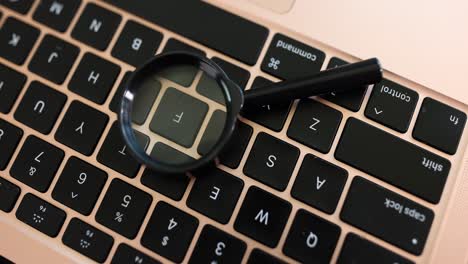 magnifying glass on a laptop keyboard