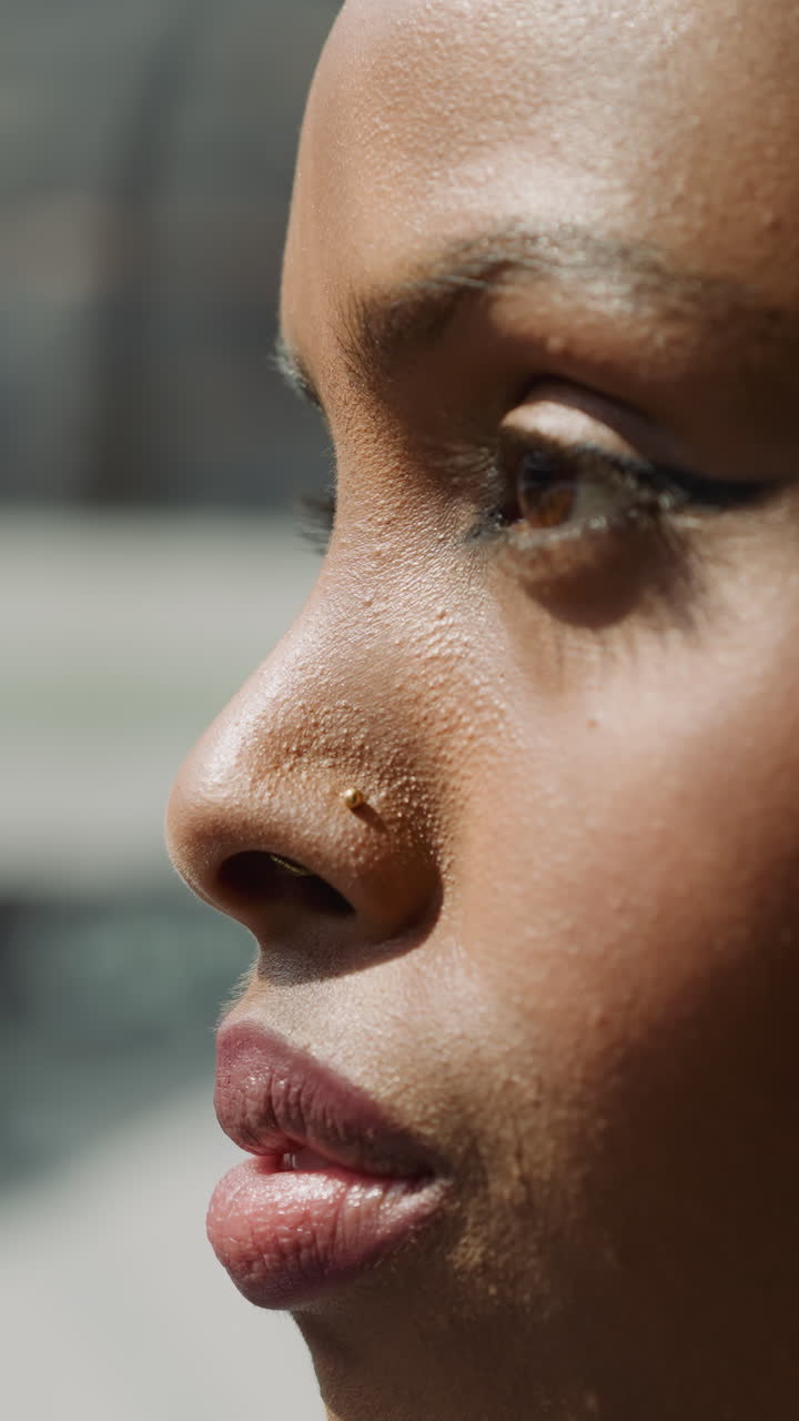 Young African-American lady with hijab looks around standing in shopping mall elevator closeup slow motion. Muslim woman with plump lips in business center