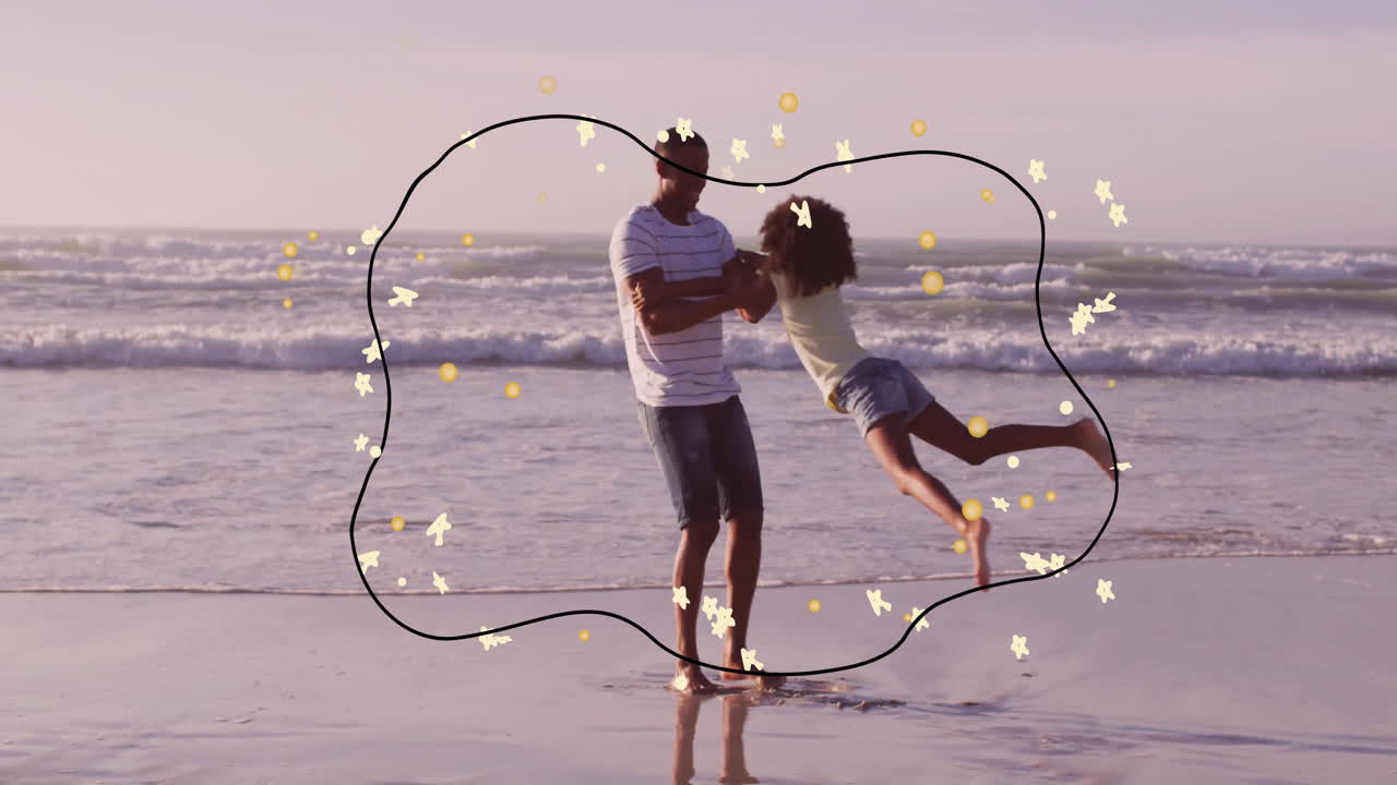 Man spinning child on beach with playful animation of stars and shapes