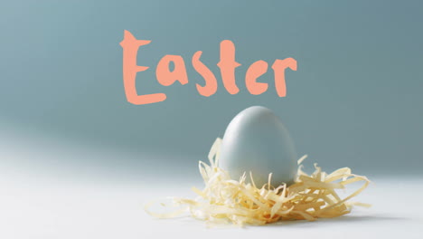 animation of easter text over blue easter egg in hey on blue background