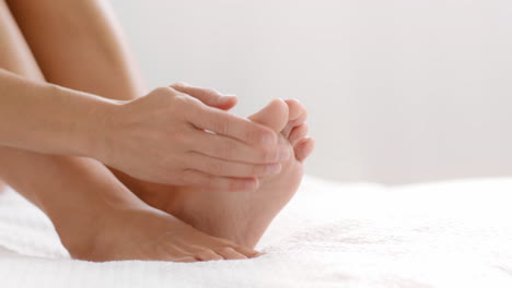 woman massaging her feet