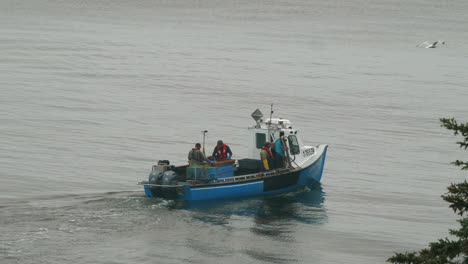 slow motion clip of a small commercial fishing boat on the st lawrence river