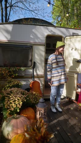 woman in a cozy autumn camper setting