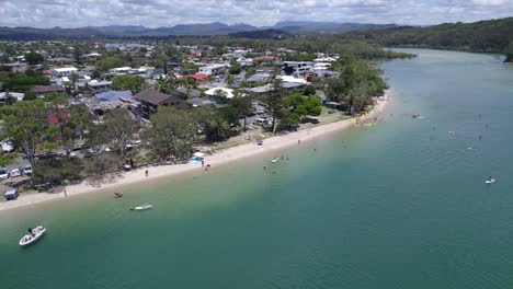people enjoying water activities in tallebudgera creek
