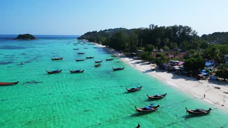 longtail-boat-beach-rocky-cliff-island-turquoise-blue-sea