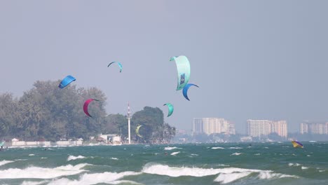 kite surfers glide over choppy ocean waves