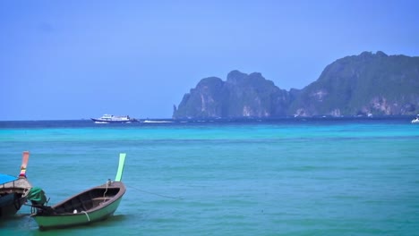 fisherman boats parked on side and bouncing on the calm blue waters