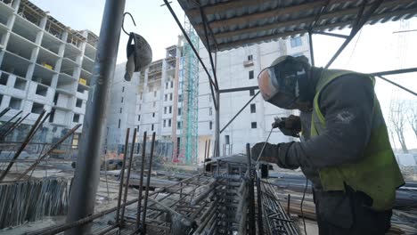 construction worker welding metal rebar for the pouring of monolithic structure