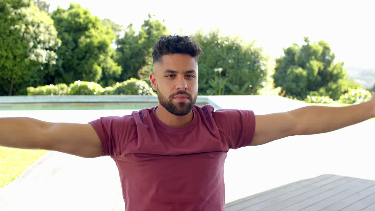 Stretching arms outdoors, man embracing peaceful moment in nature's tranquility