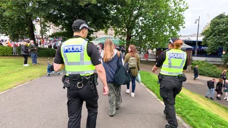 police officers walking through festival crowd