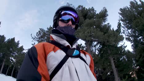 selfie video of young man skier with ski goggles going down the slope on the mountain