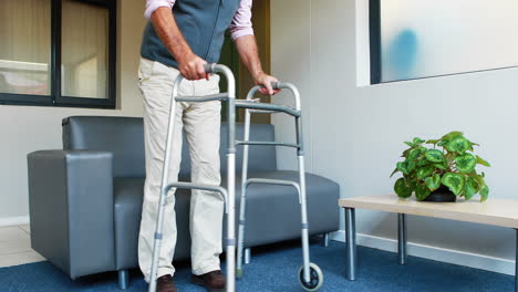 patient helping himself to have a sit thanks to his zimmer frame