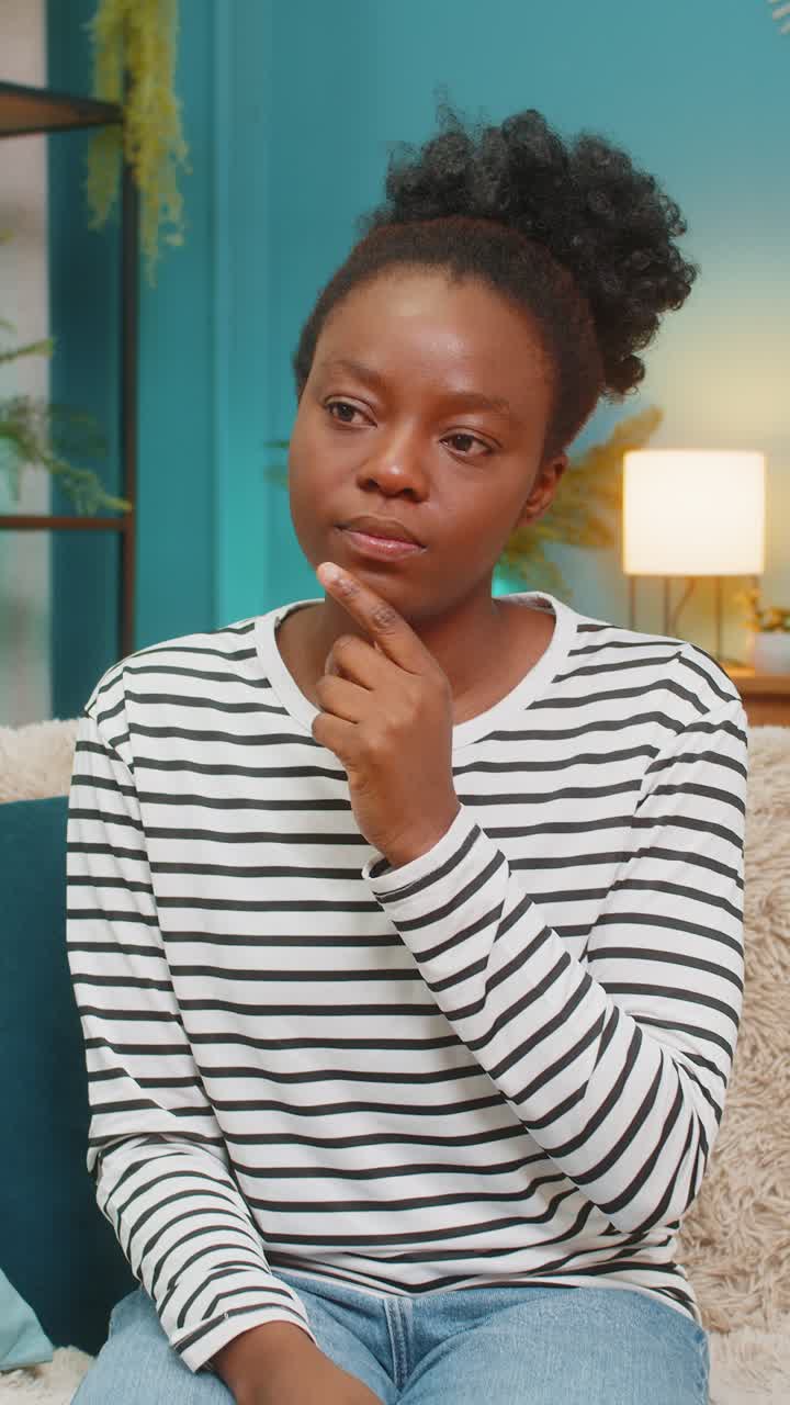 African american woman having an eureka moment raising hand in excitement after solving problem