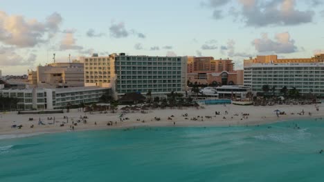backwards aerial view of luxury beachfront resort hotels