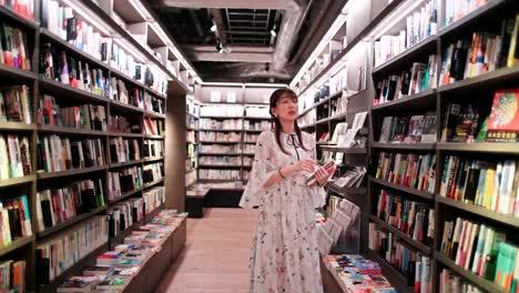woman browsing books in a modern bookstore