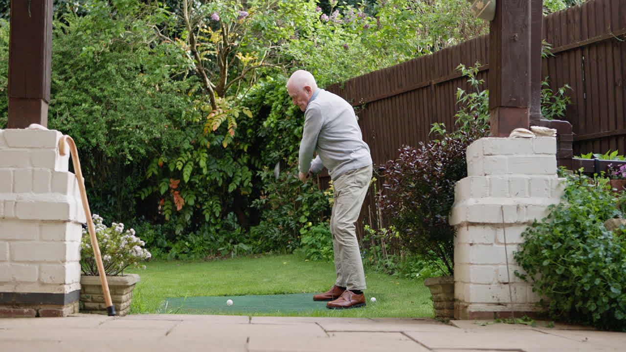 Senior man golfing in his garden