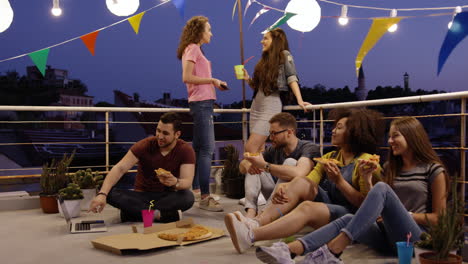 rooftop pizza party friends enjoying