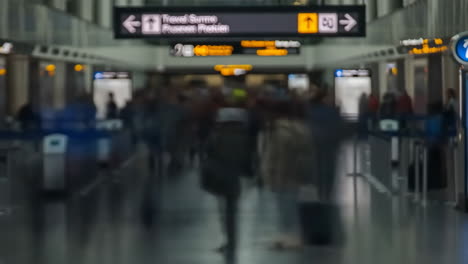 blurred crowd moving through an airport terminal