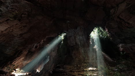 sunlight beams through a cave entrance