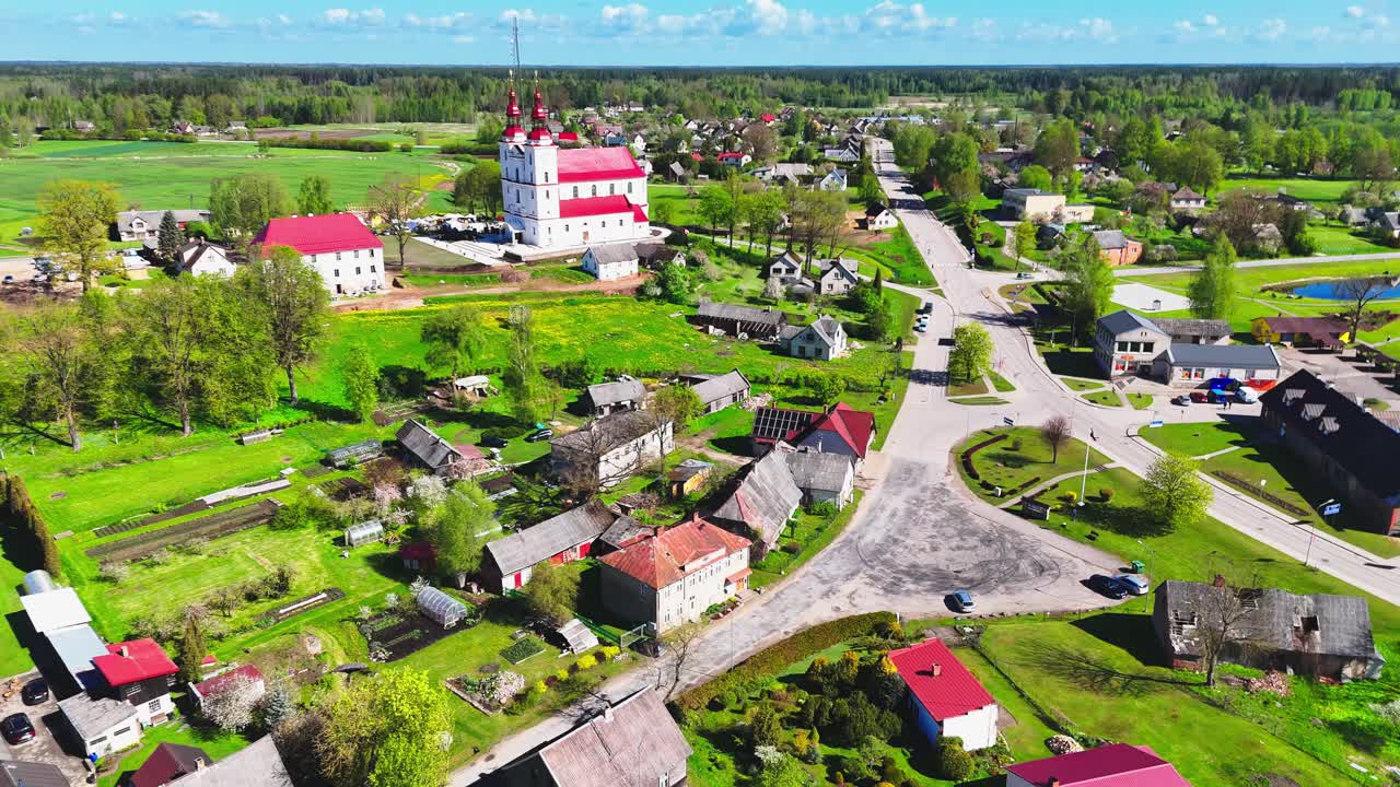 A peaceful lithuanian village, showcasing lush greenery and streets, aerial view