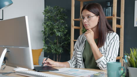 woman designer working on computer and graphics tablet