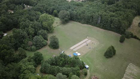 aerial hyperlapse of a group a people milling about in a large field