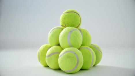 stack of tennis balls on white background 4k