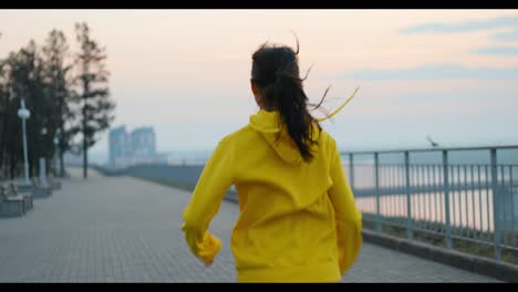 woman running in a park at sunrise