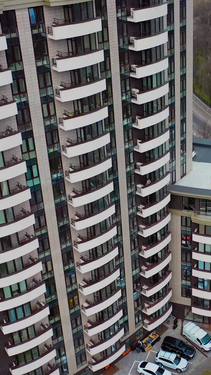 Modern residential buildings in city. Fragment of one of the serial high rise apartment buildings. Vertical video