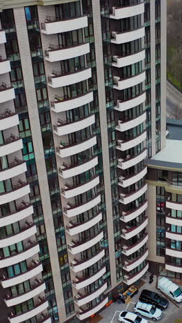 modern residential buildings in city. fragment of one of the serial high rise apartment buildings. vertical video