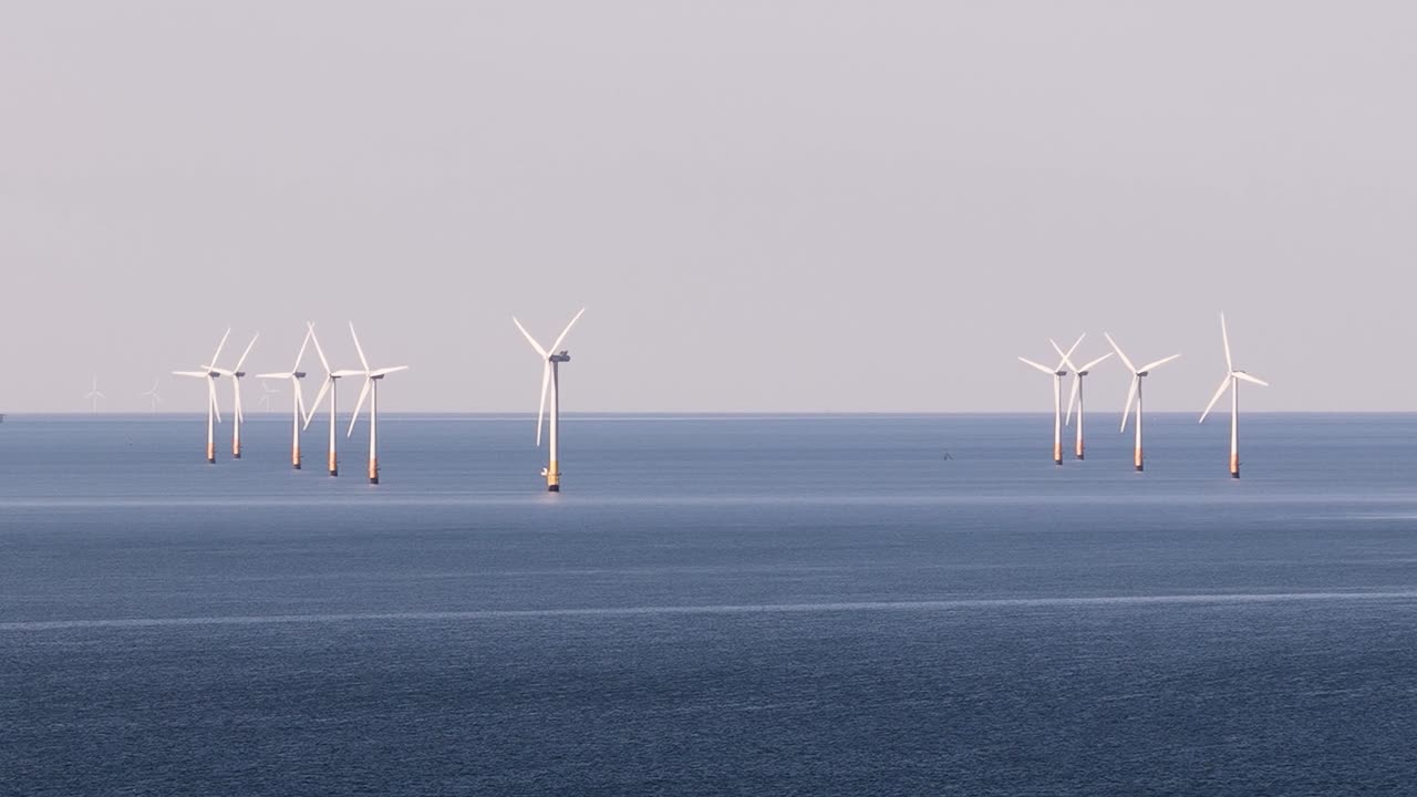 Wind turbines in UK sea, calm mood, renewable energy concept