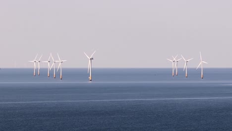 wind turbines in uk sea, calm mood, renewable energy concept
