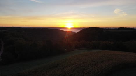 sunrise over a valley with fog and cornfields