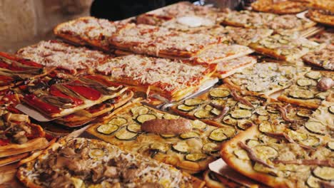 variety of pizzas on a table