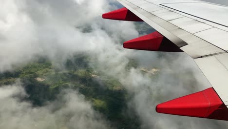 Detailed-view-of-passenger-airliner's-wing-with-flaps-fairings-and-air-brakes,-passenger-view-through-window-on-airplane