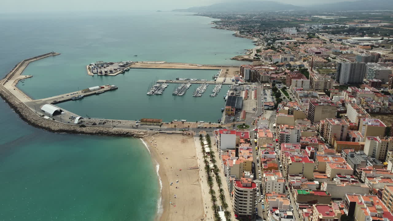 Paesaggio urbano costiero con porto turistico e spiaggia