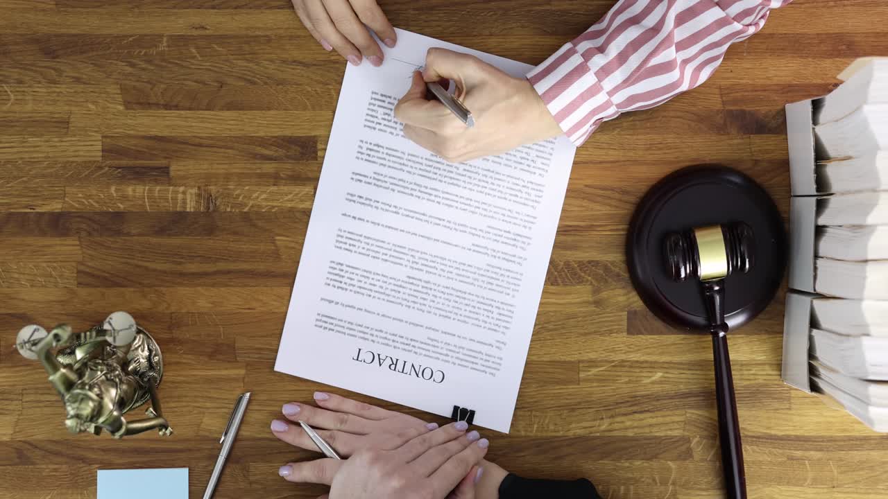 Judge giving document with contract to woman to sign in courthouse top view 4k movie
