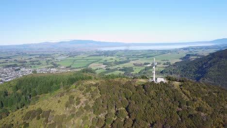 Orbiting-around-a-network-tower-to-reveal-a-small-town-and-farmland-in-the-background