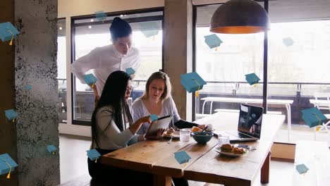 Animation-of-graduation-hats-floating-over-diverse-female-and-male-coworkers-in-office