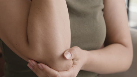 Close-Up-Of-An-Unrecognizable-Woman-Touching-Her-Painful-Elbow