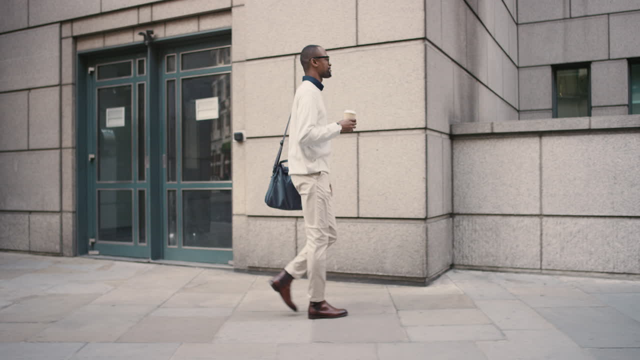 African American businessman walking through city
