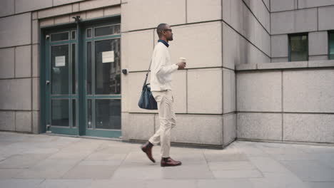 african american businessman walking through city