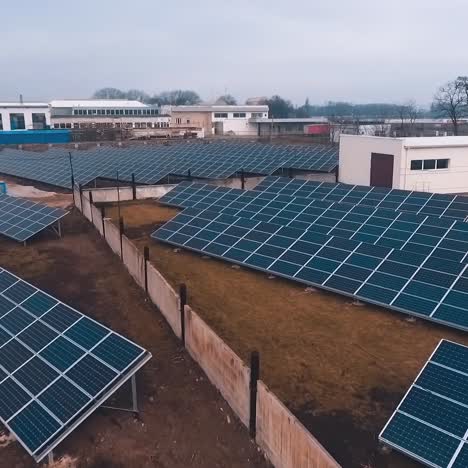 solar power station on field. solar panels for power production. solar farm. renewable green energy. alternative energy sources. drone flight. motion camera back.