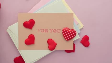 heart shape symbol and envelope on table,