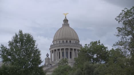 wide, dome over trees: stormy skies over the mississippi state capitol building. jackson, ms.