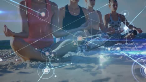 Animation-of-data-processing-over-group-of-female-friends-practicing-yoga,-meditating-at-the-beach