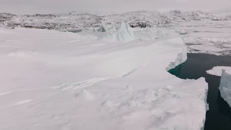 drone over sea and ice of ilulissat icefjord